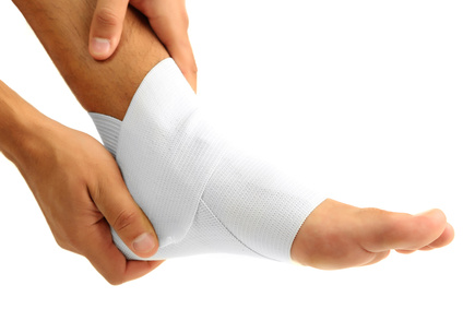 Young man with elastic bandage on leg, isolated on white